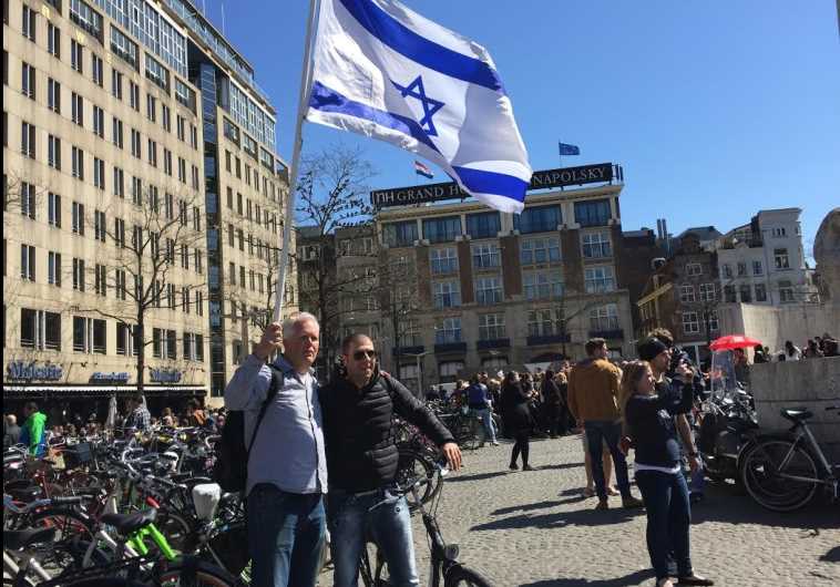 Pastor Stan Kamps waving the Israeli flag in Amsterdam as part of a campaign to fight anti-Semitism in Europe and show solidarity with European Jewry