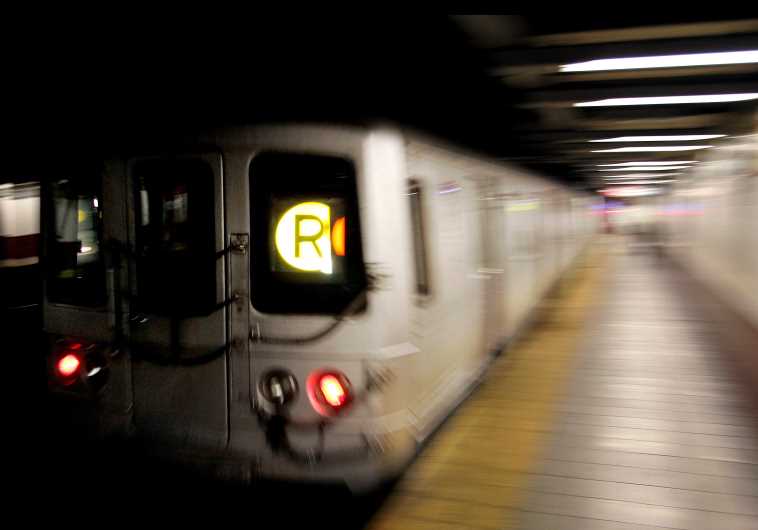 A Metropolitan Transit Authority (MTA) R-train streaks through the Canal Street subway station in downtown New York
