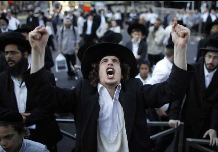 An ultra-Orthodox Jew gestures during a protest in the Mea Shearim neighborhood of Jerusalem