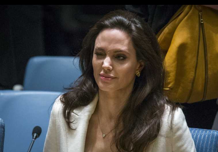 United Nations High Commissioner for Refugees special envoy, actress Angelina Jolie, winks as she arrives to speak during a Security Council meeting regarding the refugee crisis in Syria