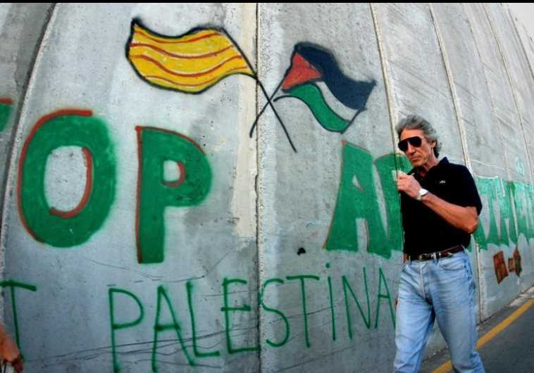 British rock star Roger Waters of Pink Floyd walks along the controversial Israeli barrier in the West Bank city of Bethlehem June 21, 2006.