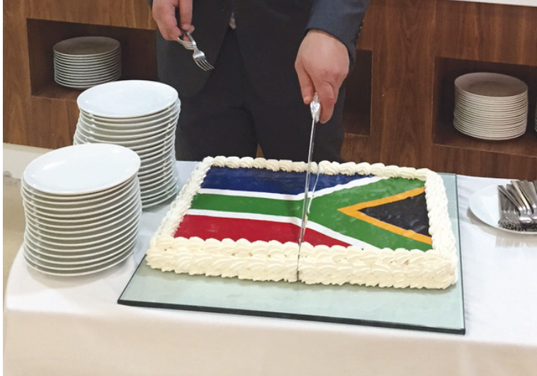 A HOTEL STAFFER cuts a cake at the event in Ramallah on Tuesday.