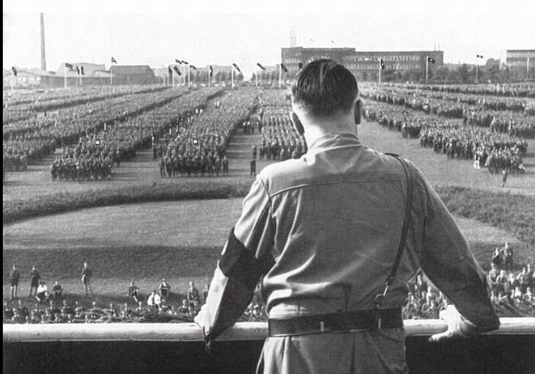 German chancellor Adolf Hitler looks out at a rally staged by the Nazi Party