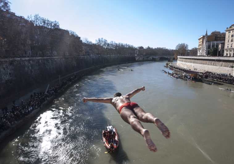 Walter Schirra of Italy, dives in the Tiber river as part of the traditional New Year celebrations on January 1, 2015 in Rome.