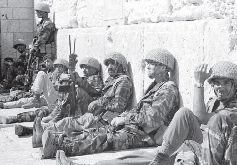 IDF soldiers sit in front of the Western Wall in June 1967 after it was captured during the Six Day War.