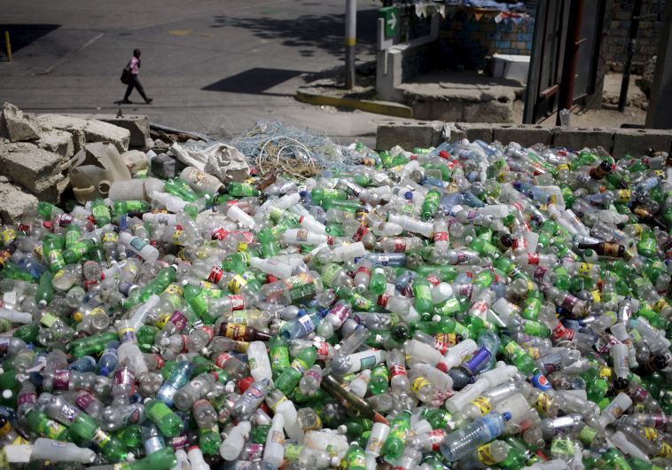 Plastic bottles to be sold for recycling are seen at a storage