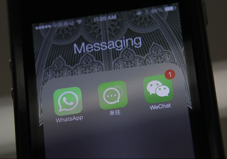 Icons of messaging applications WhatsApp of Facebook (L), Laiwang of Alibaba Group (C) and WeChat, or Weixin, of Tencent Group