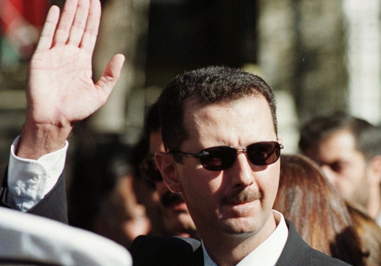 Syrian President Bashar Assad waves to supporters in Damascus