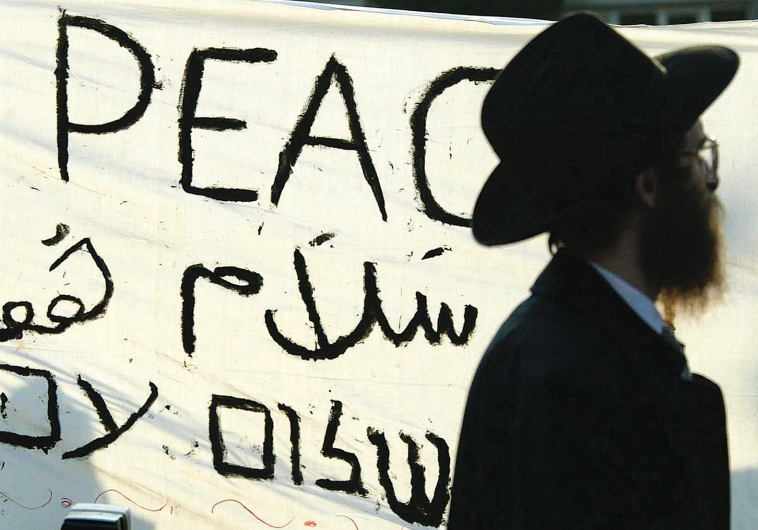 A jewish man passes a banner which reads ‘Peace Now’ during a pro-Israel demonstration held in Amsterdam several years ago.