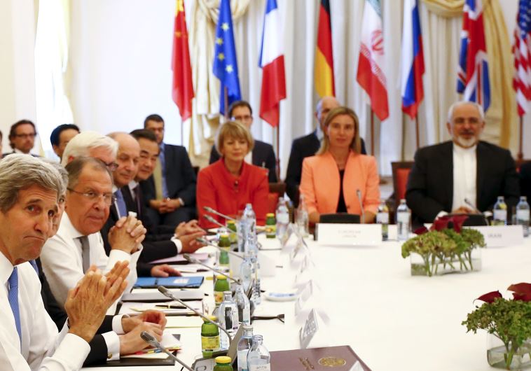 Negotiators wait for photographers during a meeting at the hotel where the Iran nuclear talks are being held in Vienna, Austria July 6, 2015.