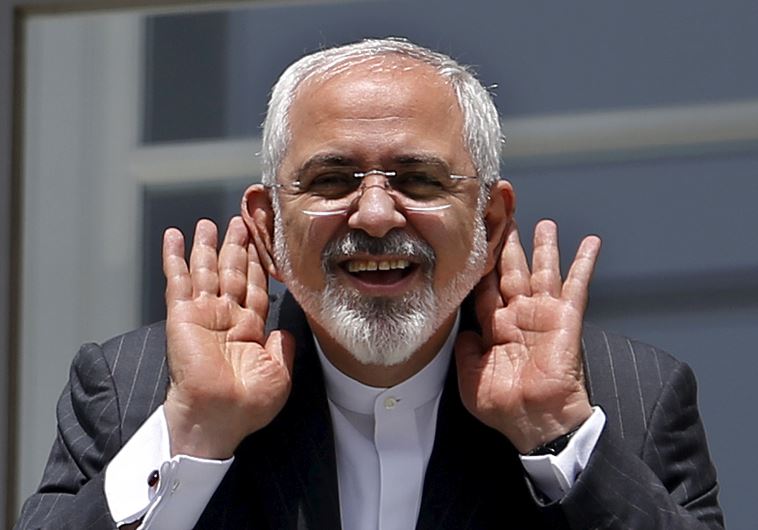 Iranian Foreign Minister Mohammad Javad Zarif gestures as he talks with journalist from a balcony of the Palais Coburg hotel where the Iran nuclear talks meetings are being held in Vienna, Austria