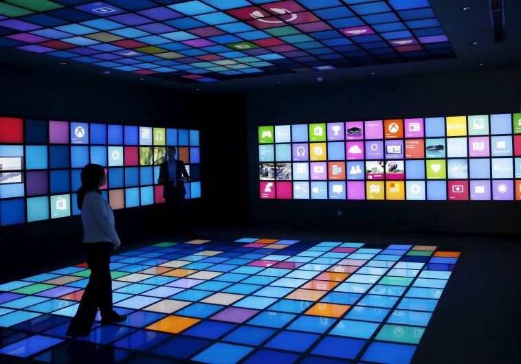 A reporter looks around a display of Microsoft China Center One