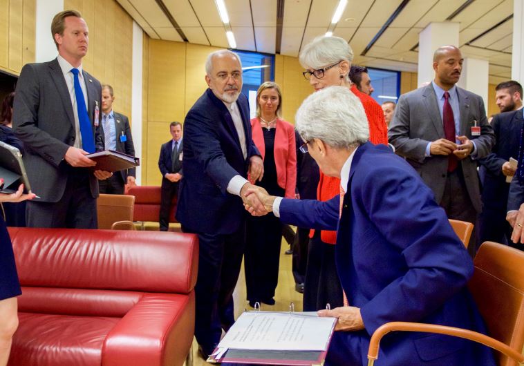 U.S. Secretary of State John Kerry shakes hands with Iranian Foreign Minister Javad Zarif as he prepares to leave the Austria Center in Vienna, Austria, on July 14, 2015, after the European Union, United States, and the rest of its P5+1 partners reached agreement on a plan to prevent Iran from obtai