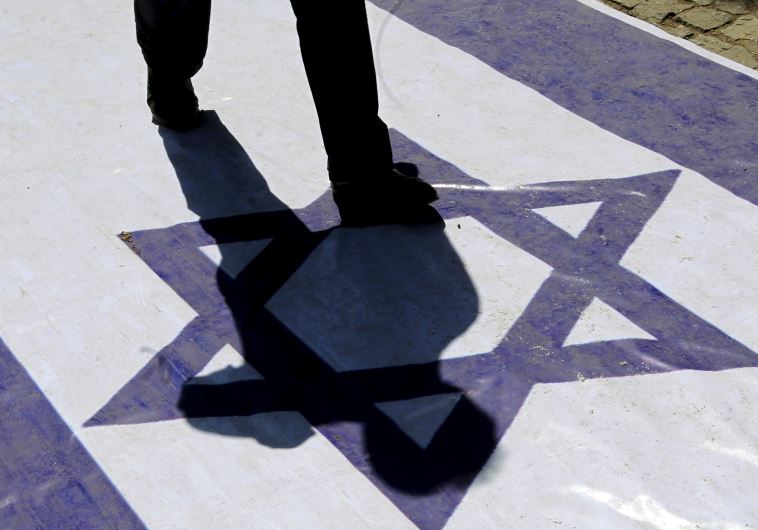 A demonstrator steps on an Israeli flag during a rally marking al-Quds (Jerusalem) Day in Tehran