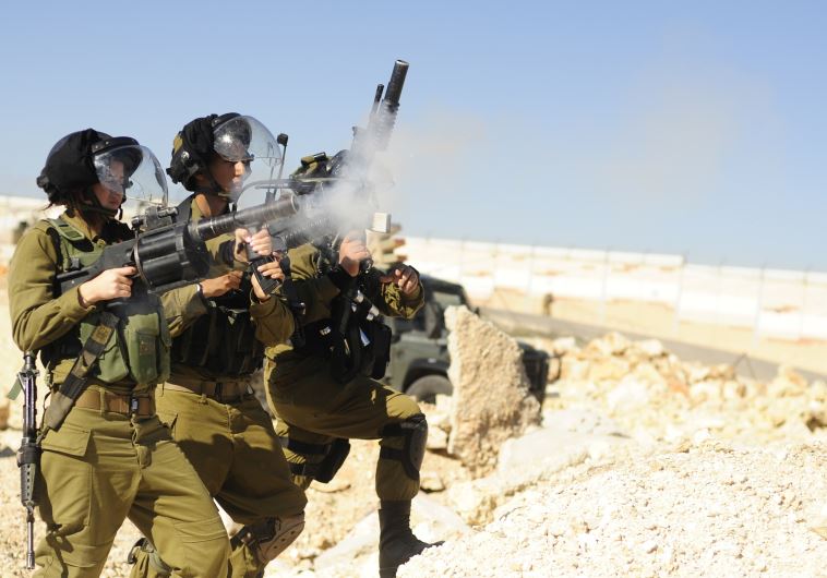 A Home Front Command soldier fires an automatic grenade launcher during training