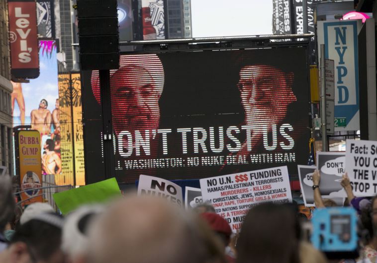 An image of Iranian leaders is projected on a giant screen in front of demonstrators during a rally opposing the nuclear deal with Iran in Times Square, July 22, 2015