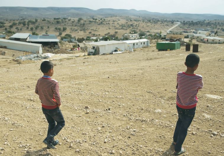 BEDUIN BOYS walk toward the ‘unrecognized’ village of Um Al-Hiram in the Negev.
