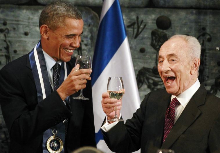 US President Barack Obama toasts with former president Shimon Peres after Obama was presented with the Presidential Medal of Distinction, Israel's highest civilian honor, in Jerusalem, March 21, 2013