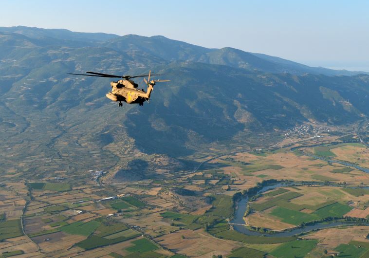 Israeli Apache helicopter flies over Greece's mountainous countryside during a joint-training exericise with the Greek military