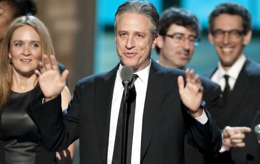 Talk show host Jon Stewart, flanked by his writers and correspondents, speaks after receiving the Best Late Night Comedy Series Award for his show