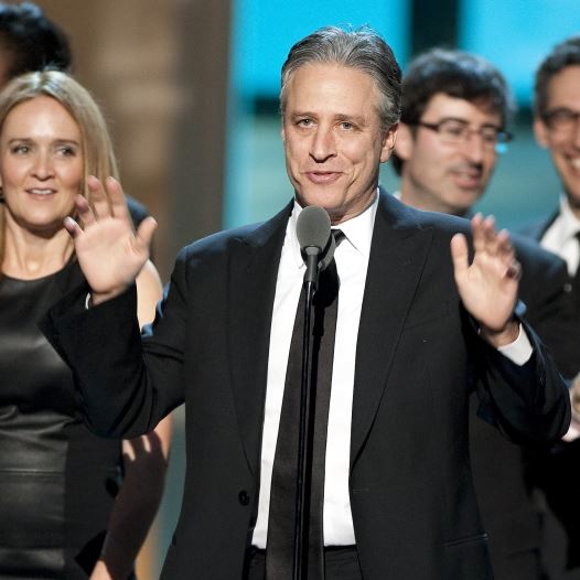 Talk show host Jon Stewart, flanked by his writers and correspondents, speaks after receiving the Best Late Night Comedy Series Award for his show