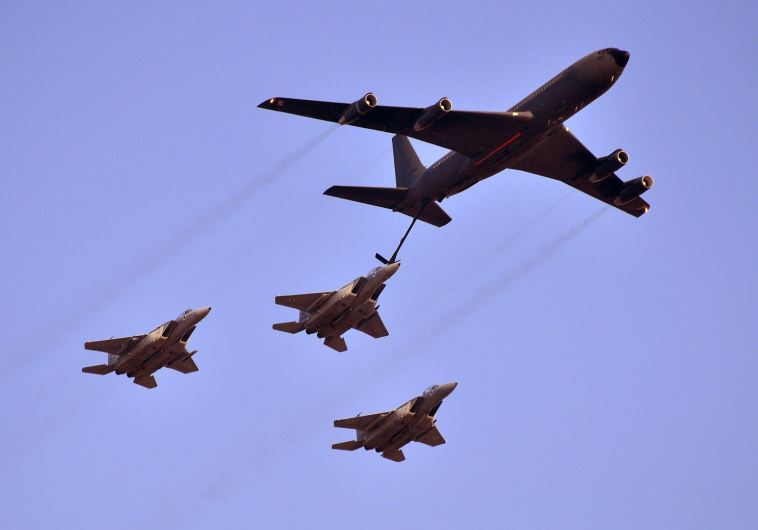 A Boeing 707 aerially refuels three F-15 Eagles