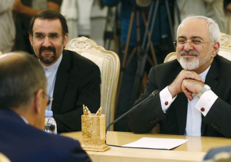 Iranian FM Mohammad Javad Zarif (right) listens to his Russian counterpart Sergei Lavrov (back facing) during their meeting in Moscow, Russia,
