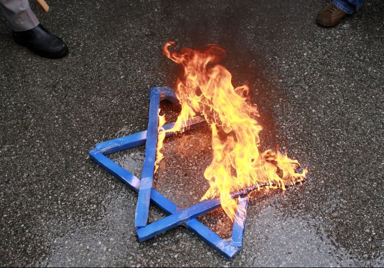 A Star of David burns in flames during a protest against Israeli attacks on Gaza in front of the Israeli embassy in Ankara