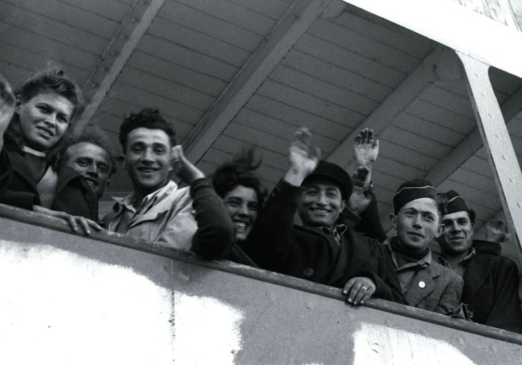 NEWLY ARRIVING Jewish refugees from Europe wave from the ship ‘S.S. Awarea’ as it pulls into Haifa port in 1948