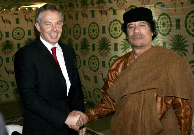 Britain's Prime Minister Tony Blair shakes hands with Libyan leader Muammar Gaddafi near Gaddafi's home town of Sirte May 29, 2007.