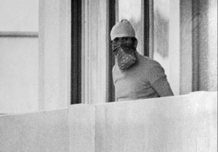 A member of the Palestinian terrorist group Black September appears on the balcony of the Israeli house at the Munich Olympic village on September 5, 1972