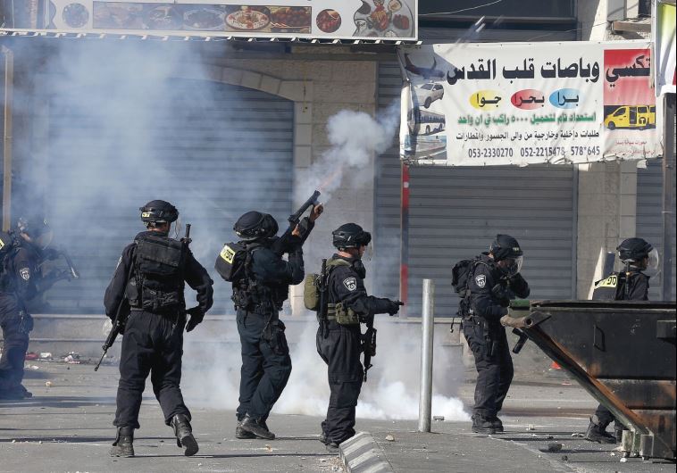 BORDER POLICEMEN fire tear gas at rock-throwers in the Shuafat refugee camp in northeastern Jerusalem on Friday