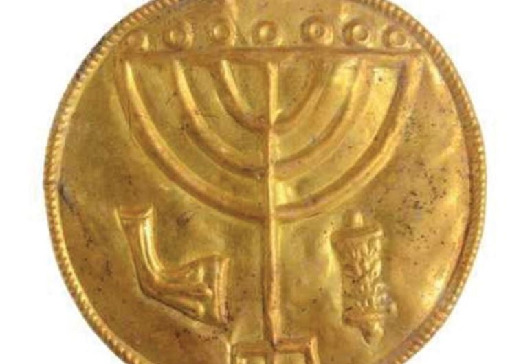 A 10 CM. medallion recently discovered at the foot of the Temple Mount with a menorah etched inside