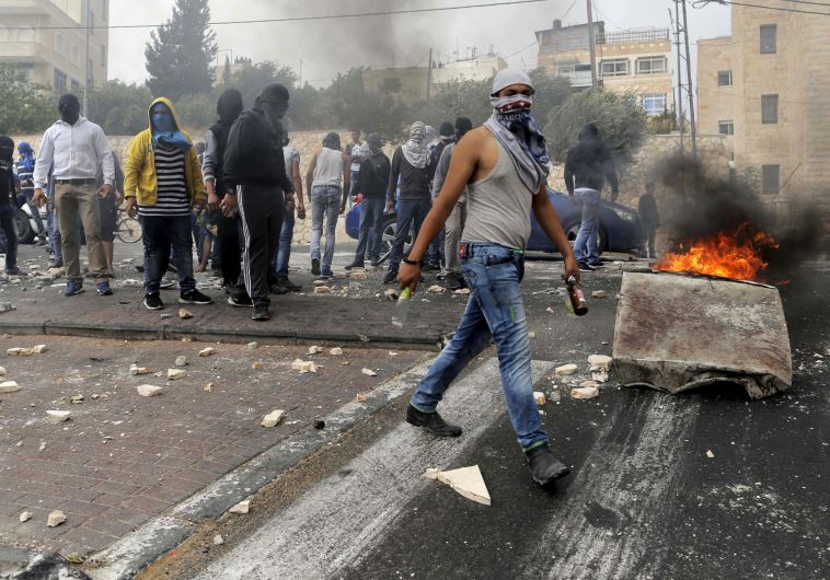 Stone-throwing Palestinians clash with Israeli police in Sur Baher, a village in the suburbs of east Jerusalem