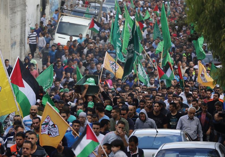 MOURNERS CARRY the body of a Palestinian killed in clashes with Israeli forces in east Jerusalem.