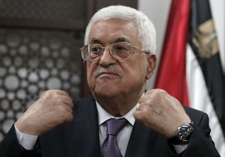 Palestinian Authority President Mahmoud Abbas speaks with journalists at his office in the West Bank city of Ramallah