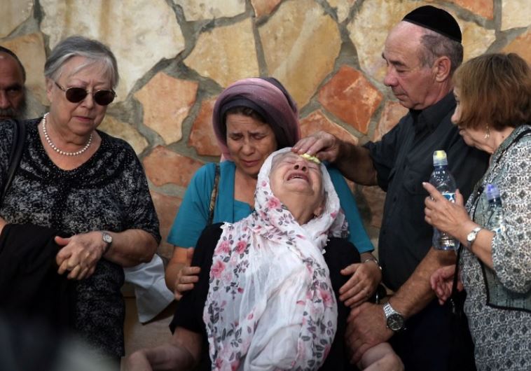 The mother of 51-year-old Israeli Alon Guverg, who was killed a day earlier when Palestinian attackers shot at a bus, mourns during his funeral procession in Jerusalem