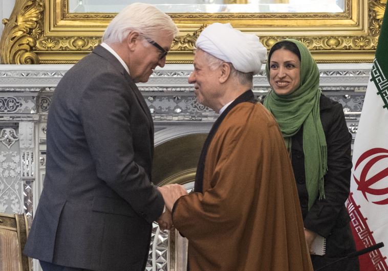 Chairman of Iran's Expediency Council Ali Akbar Hashemi Rafsanjani (R) shakes hands with German Foreign Minister Frank-Walter Steinmeier in Tehran