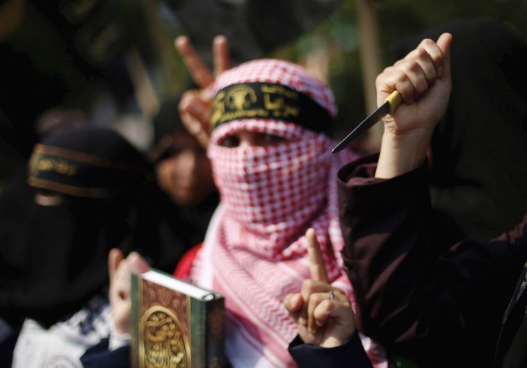 A PALESTINIAN woman holds up a knife in the Gaza Strip.
