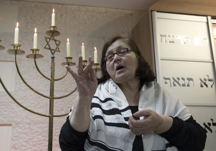 A sign language interpreter translates a prayer during a ceremony on the eve of the International Day of Commemoration to honour the victims of the Holocaust in Minsk