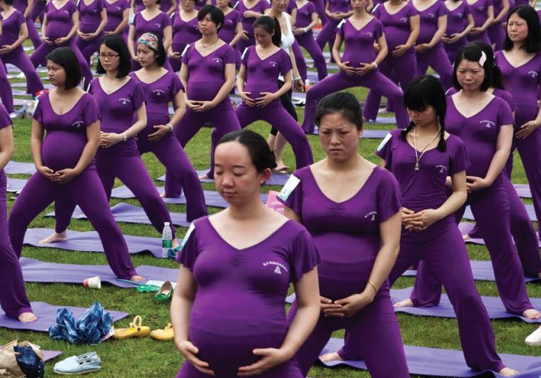 PREGNANT WOMEN practice yoga as they attempt to break the Guinness World Record for the largest prenatal yoga class, in Changsha, Hunan province last year