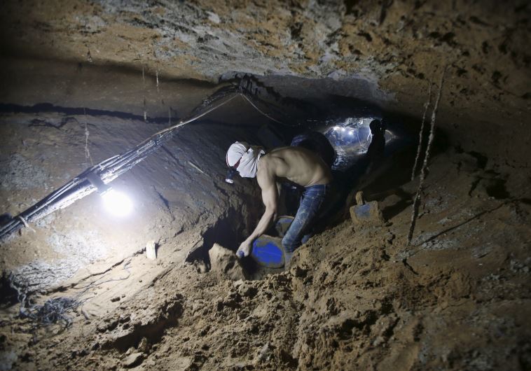 A Palestinian worker repairs a smuggling tunnel after it was flooded by Egyptian security forces, beneath the border between Egypt and southern Gaza Strip