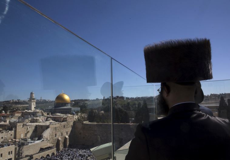 An ultra-Orthodox Jewish man stands on the rooftop during a special priestly blessing for Passover at the Western Wall