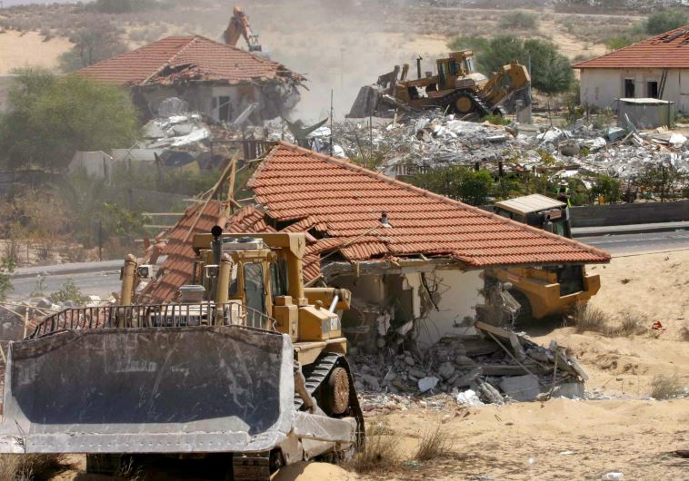 Bulldozers and earthmoving equipment demolish homes in the former Jewish settlement of Neve Dekalim, in the Gaza Strip August 31, 2005. 