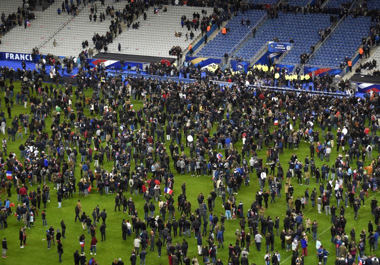 Soccer fans wait for security clearance to leave the Stade de France in Saint-Denis, north of Paris, after the friendly football match France vs Germany on November 13, 2015