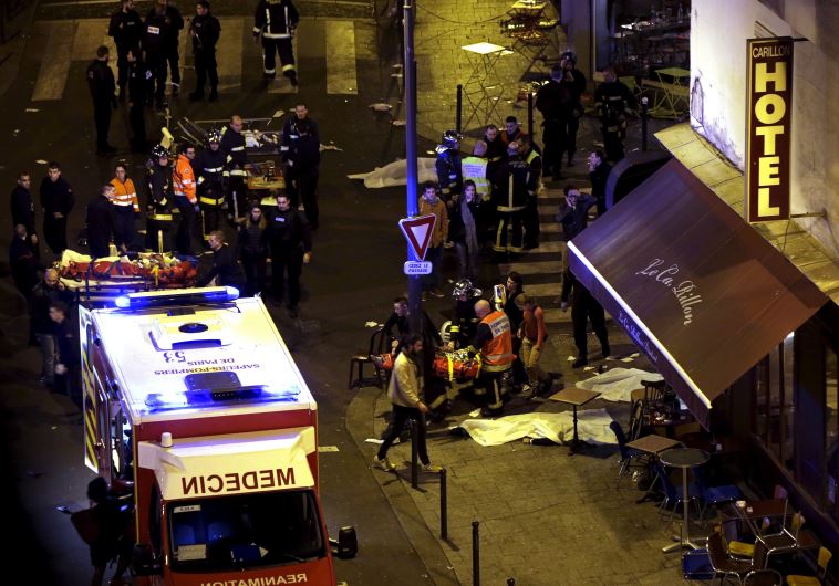 Rescue service personnel working outside a restaurant following shooting incidents in Paris, France, November 13, 2015