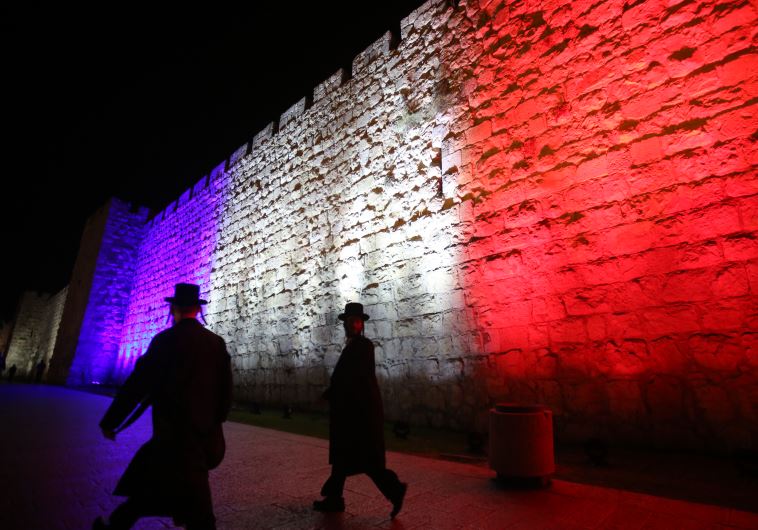 Wall of Jerusalem's old city lit up in colors of French flag