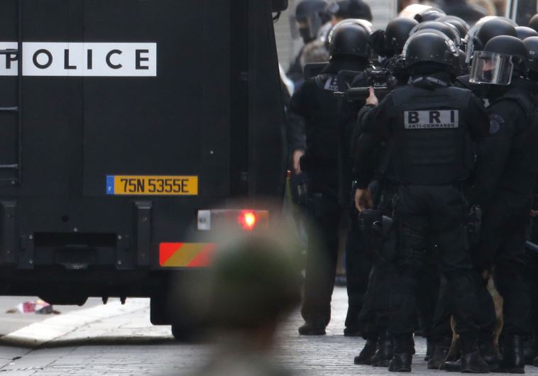 Members of French special police forces of the Research and Intervention Brigade (BRI) are seen near a raid zone in Saint-Denis, near Paris, France, November 18, 2015 