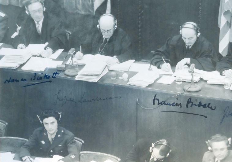 George Sakheim at left, in front of judges at Nuremberg Trial, 1946. The photo was signed by British and American judges
