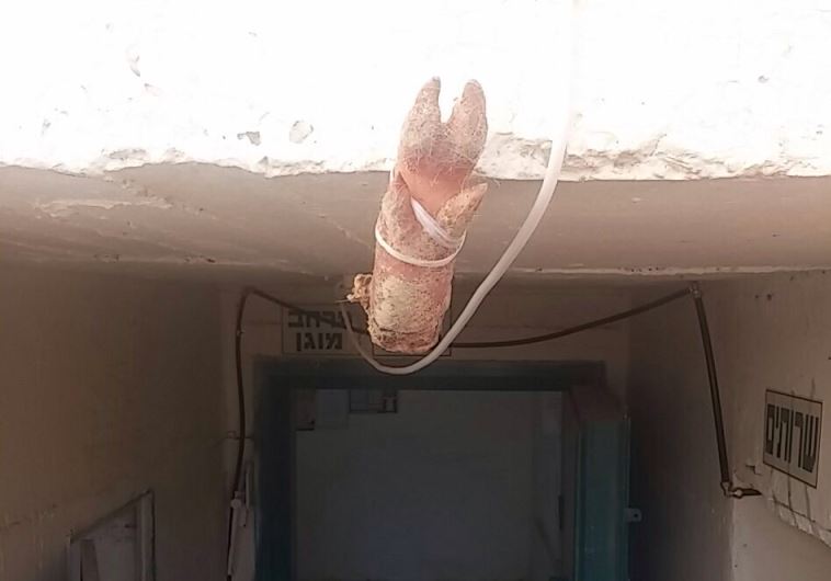 A pig's foot hung outside a synagogue in Arad